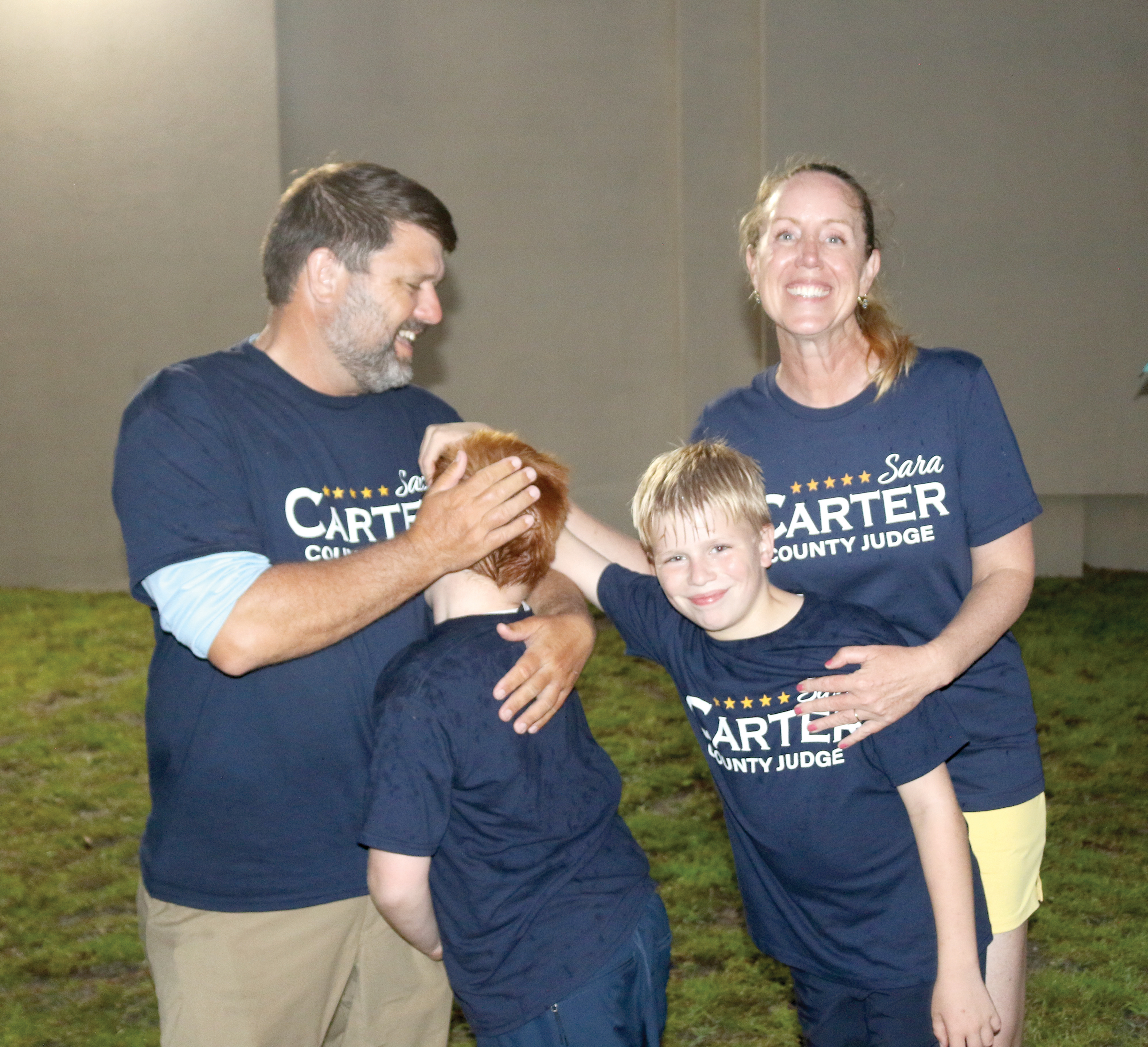 Sara Carter celebrates with her husband, Travis, and sons, Jack (left) and George after winning re-election as Columbia County judge on Tuesday night. (TONY BRITT/Lake City Reporter)