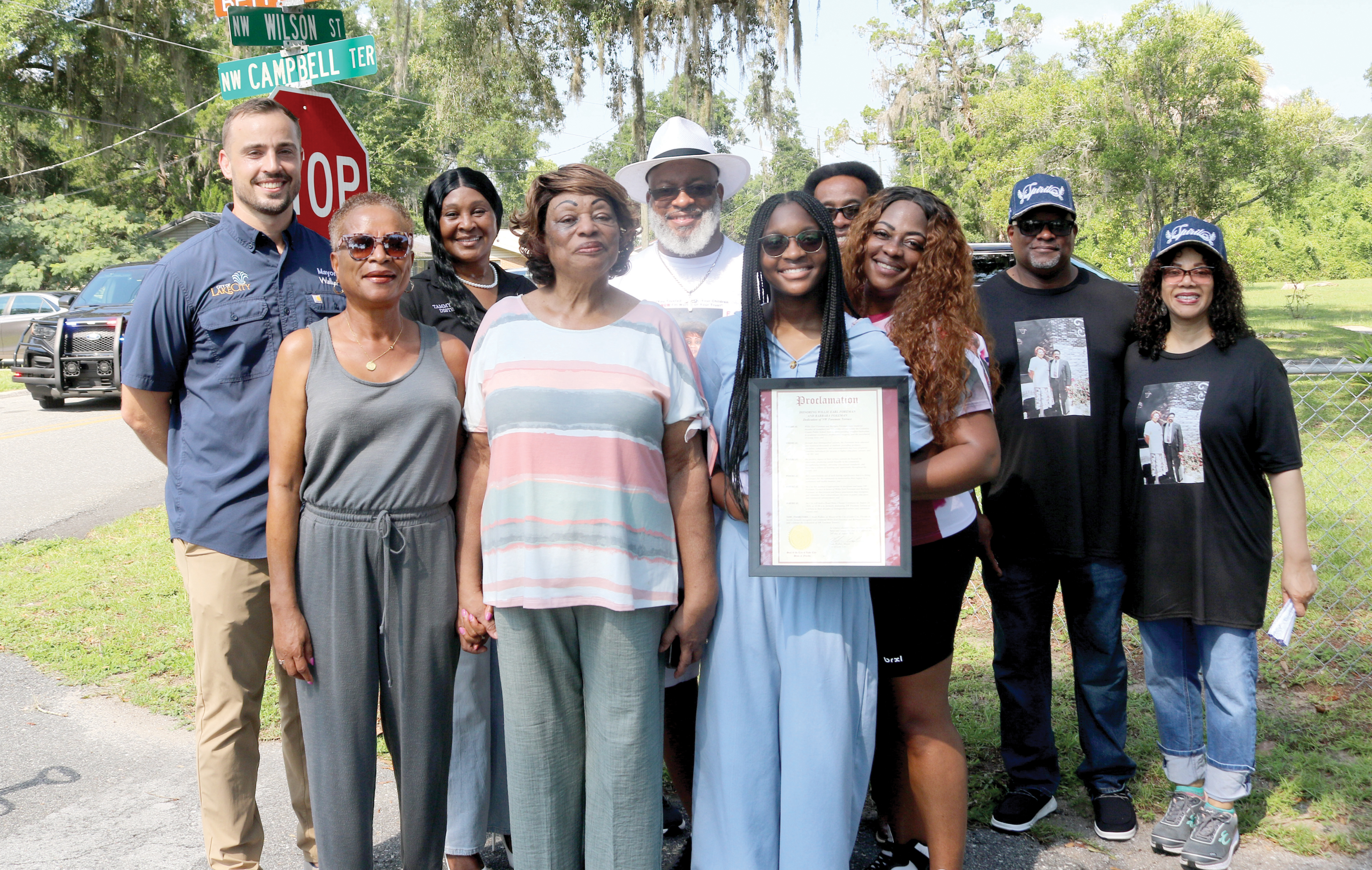 Lake City Mayor Noah Walker (far left) stands with council member Tammy Harris and members of the Layne and Foreman families after renamed streets dedicated to the families were unveiled on Tuesday morning. (TONY BRITT/Lake City Reporter)