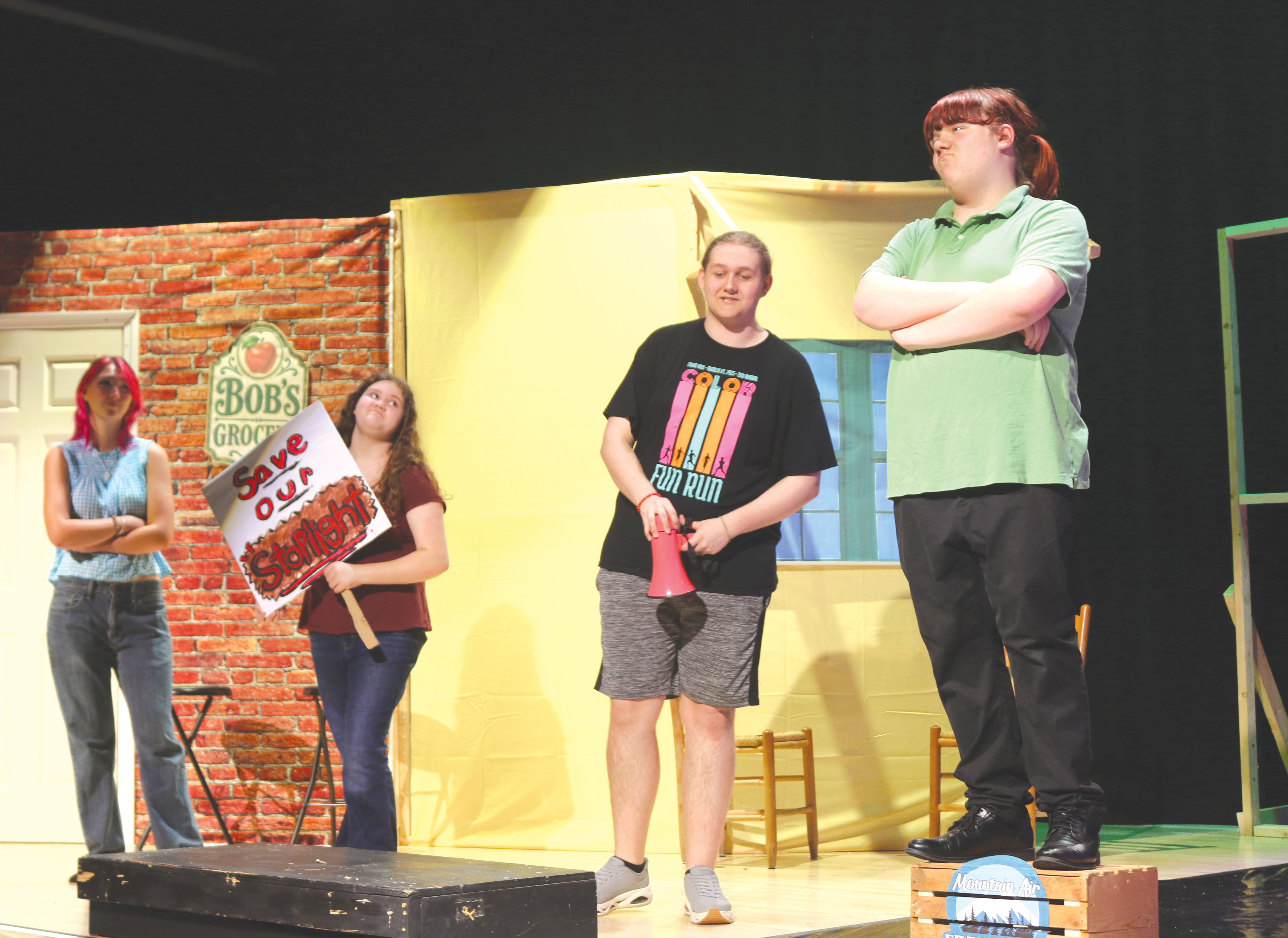 Clover Greene (from left), Chelsey Love, Logan Wright and Gavin Thomas participate in a scene where they discuss the town’s lone stop light in Fort White High School Theater’s upcoming production of ‘One Stoplight Town.’ (TONY BRITT/Lake City Reporter)