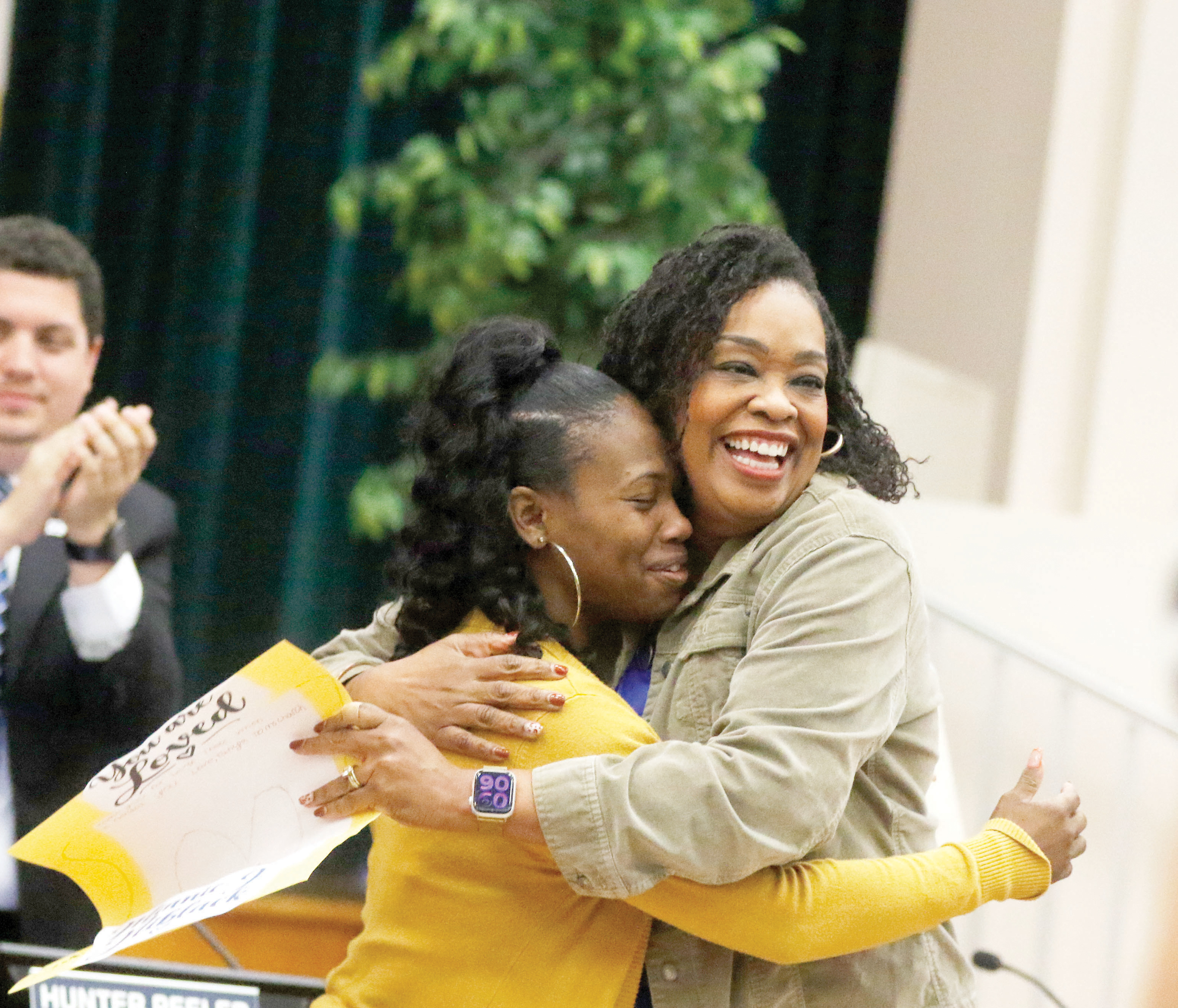 Minnie J. Niblack Elementary Principal Makeba Murphy (right) hugs Saporia Church on Tuesday morning after Murphy and the Columbia County School Board honored Church, a paraprofessional at the school, for saving a student’s life last month. (JAMIE WACHTER/Lake City Reporter)