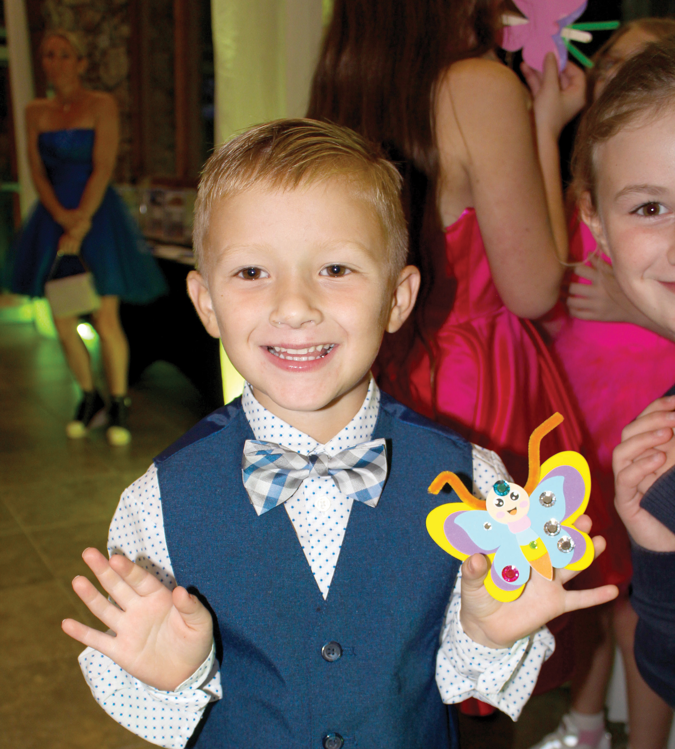 A child shows off a butterfly at last year’s inaugural Laced Up for Love Sneaker Ball. The Catholic Charities fundraiser returns later this month with a sneaker drive added. (COURTESY)