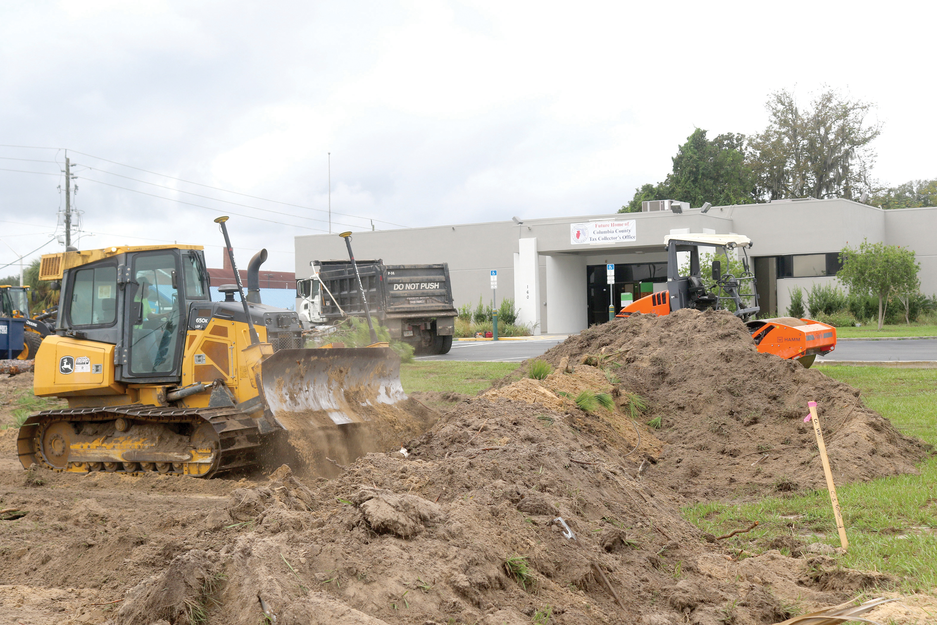 Crews have begun work on expanding the parking lot at the former TD Bank building on NW Main Boulevard for the new Columbia County Tax Collector’s Office. (TONY BRITT/Lake City Reporter)
