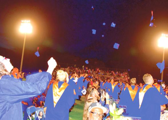 Branford High graduates toss their caps into the air after graduating during Friday’s commencement ceremony. (ROB WOLFE/Lake City Reporter)