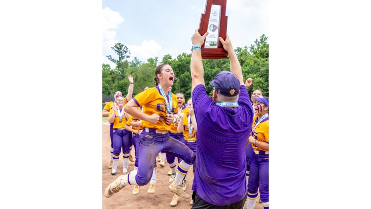 Columbia shortstop Alannah Lord (left) celebrates as coach Joe Saucier (right) hoists the Class 4A state championship trophy after the Tigers defeated Lake Wales for the title on May 23. (JACK HOWDESHELL/Lake City Reporter)