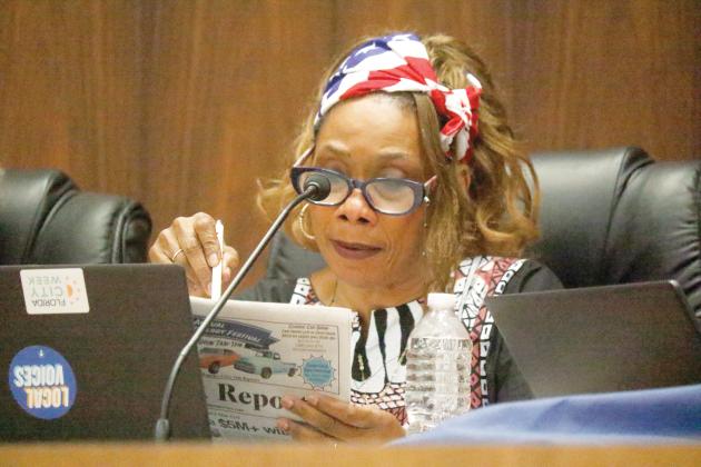Live Oak Councilwoman Vanessa Brown Robinson looks at last week’s Live Oak Reporter to reference the impact the city budget would experience from the proposed property tax cuts during Tuesday’s council meeting. (JAMIE WACHTER/Lake City Reporter)