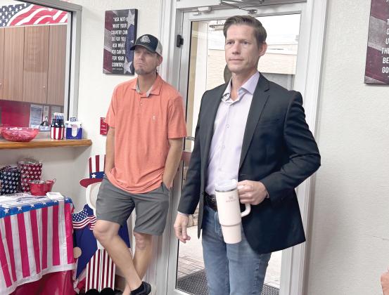 Adam Collins (right) listens as the results were delivered Tuesday night in the Live Oak District 1 runoff election. Collins won the election. (JAMIE WACHTER/Lake City Reporter)