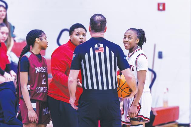 Fort White coach Bregay Harris questions a call to a referee while guard Javiona Roberson (right) smiles during the Region 3-R semifinals against Madison County on Feb. 13. (FILE)