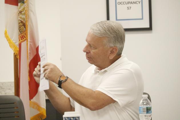 North Florida Water Utilities Authority Attorney Grady Williams holds up one of the agreements that established the NFWUA during Monday’s meeting. Williams and Executive Director Shannon Roberts asked the board for direction as far as to the timeline for transferring assets from Columbia and Suwannee counties to the Authority. (JAMIE WACHTER/Lake City Reporter)