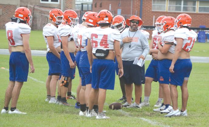 Branford coach Will Dettor works with his defensive line during Thursday’s practice. (MORGAN MCMULLEN/Lake City Reporter)