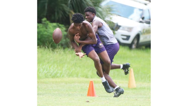 Columbia defensive back Monterrence Williamson breaks up a pass intended for receiver Shaheed White in 7-on-7 drills during Tuesday’s summer workout. (JORDAN KROEGER/Lake City Reporter)