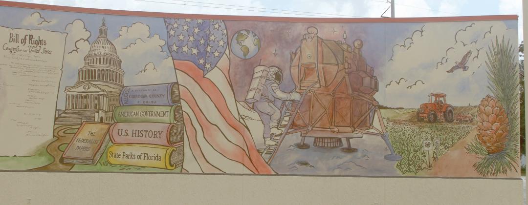 The mural by Cosby Hayes on the outside of the Columbia County Public Library’s West Branch detailing America’s history is now completed after Hayes added color to the various scenes from the past 250 years. (JAMIE WACHTER/Lake City Reporter)