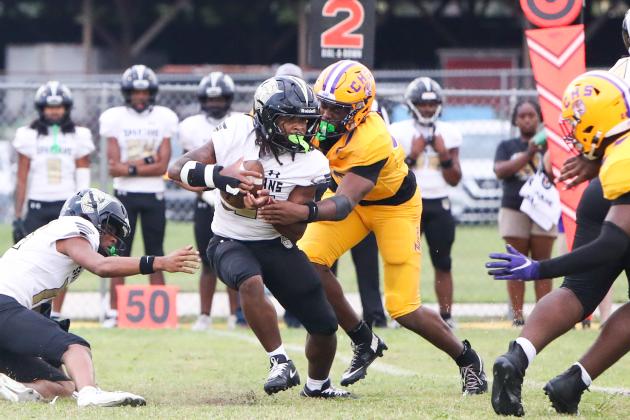 Columbia defensive end Mikel Morgan tackles Lakewood running back Amir Smith in the backfield on Friday. (BRENT KUYKENDALL/Lake City Reporter)