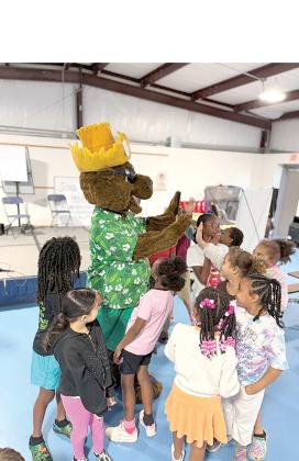 Niblack students high five Bellamy as he reminds them to ‘Turn off the Tap!’ (COURTESY UF/IFAS EXTENSION COLUMBIA COUNTY)