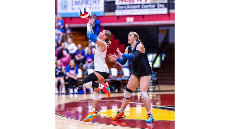 Branford libero Ava Alcorn (left) defends a shot while outside hitter Anabella Dicks looks on against Chipley during last season’s Class Rural state championship. Alcorn and Dicks are the only returning starters for the Buccaneers this season. (JACK HOWDESHELL/Lake City Reporter)