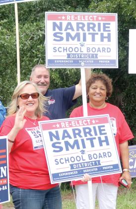Narrie Smith (right) holds a campaign sign alongside a supporter Tuesday outside the Supervisor of Elections office. (TONY BRITT/Lake City Reporter)