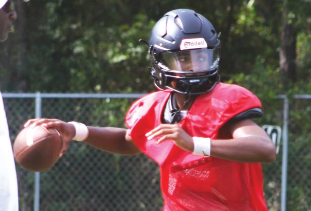 Fort White quarterback Chance Johnson rolls out for a pass during Monday’s practice. (MORGAN MCMULLEN/Lake City Reporter)