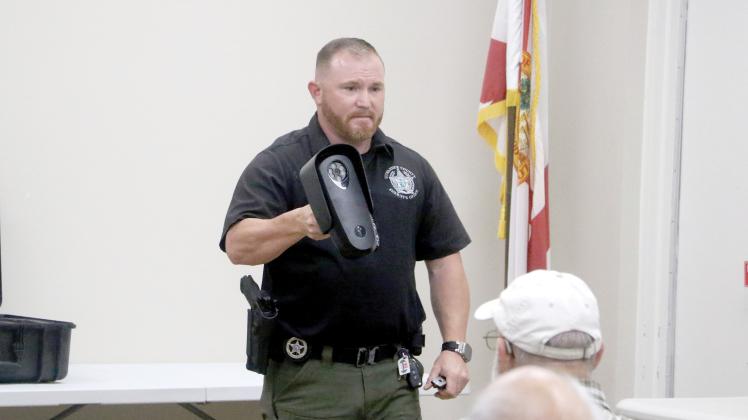 Suwannee County Sheriff’s Office Investigator Jacob Williamson shows nearly 30 people at the Suwannee River Regional Library’s Live Oak branch a Flock camera during Monday’s community meeting. (MORGAN MCMULLEN/Lake City Reporter)