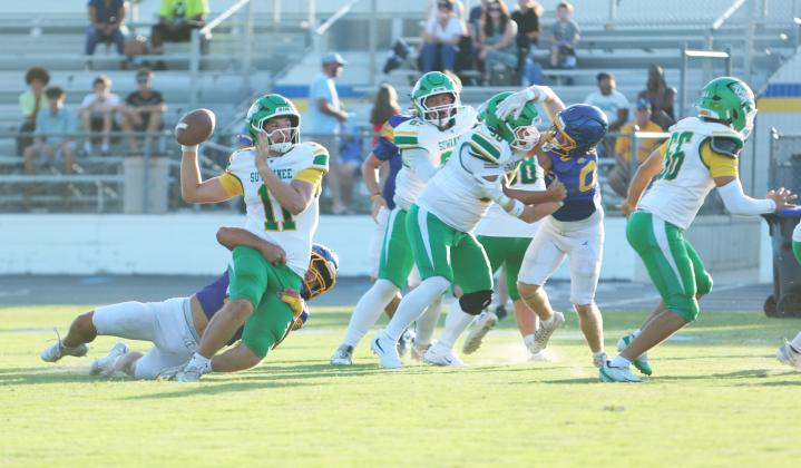 Suwannee quarterback Haigen Johnson throws as he’s being tackled from behind Friday night. Johnson connected with Kamari Lovett for a 66-yard touchdown on the play. (PAUL BUCHANAN/Lake City Reporter)