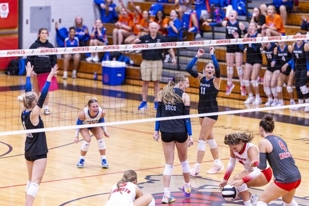 Branford middle blocker Raelea Bradow (6) looks back as her block of Lafayette hitter Sophia Kendrick's (8) attack hits the court Thursday night. (JACK HOWDESHELL/Lake City Reporter)