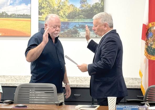 North Florida Utilities Authority board member Jock Phelps (left) is sworn in ahead of Monday’s meeting by NFWUA Attorney Grady Williams. Monday was Phelps’ first meeting as a member of the utility board. (JAMIE WACHTER/Lake City Reporter)