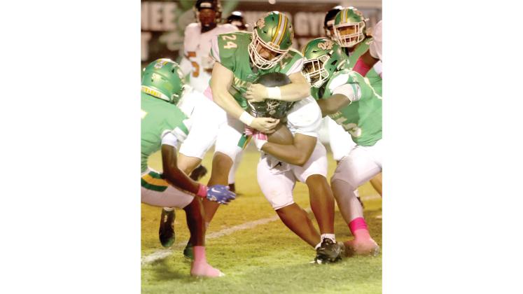 Suwannee linebacker Kyler Watson wraps up an Atlantic Coast ballcarrier last year. (PAUL BUCHANAN/Lake City Reporter)