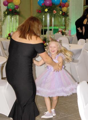 A child laughs while dancing at the inaugural Laced Up for Love Sneaker Ball last year. (COURTESY)