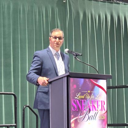 Lee Pinchouck, the director of the Foundation for Florida Gateway College, speaks at the Laced Up for Love Sneaker Ball on Saturday, which raised funds for Catholic Charities. (MONJA SLATER/Lake City Reporter)