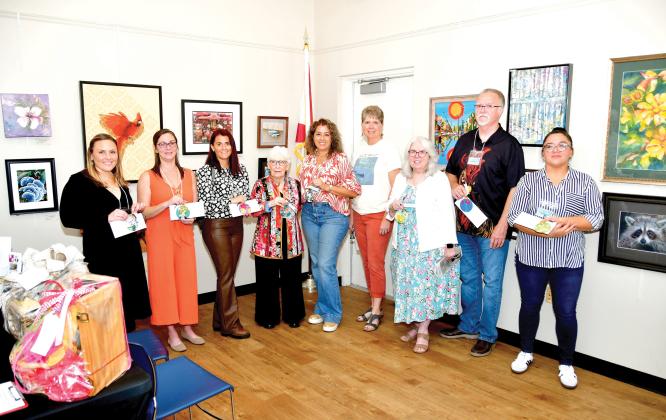 Winners in the Autum ArtFest, which is hosted by the Live Oak Artists Guild, Rachel Budwick (from left), April Phinazee, Jennifer Houston, Anda Chance, Mabel Gonzalez, Sharon Hester, Vaster Fryar, George Fryar and Mariena Craig. (ROB WOLFE/Lake City Reporter)