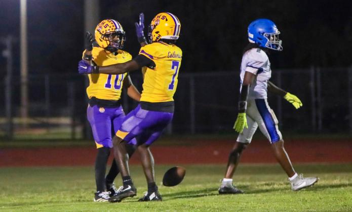 Columbia receiver Antonio Days (10) celebrates with receiver Kyren Caldwell (7) after one of his two touchdown receptions against Riverside on Friday. (BRENT KUYKENDALL/Lake City Reporter)