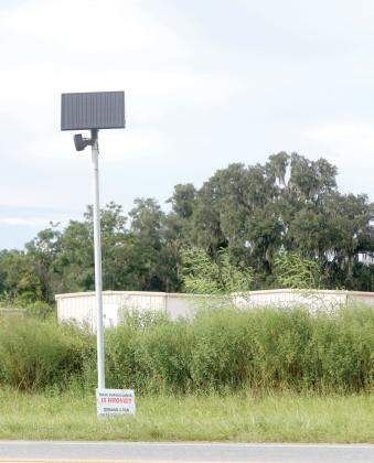 A Flock Safety camera sits along U.S. Highway 90 on the east side of Live Oak on Tuesday. (JAMIE WACHTER/Lake City Reporter)