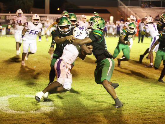 Suwannee safety Josh Johnson (right) and linebacker Marco Rojas wrap up Gainesville running back Javaris Gardner for a loss Friday night. (PAUL BUCHANAN/Lake City Reporter)