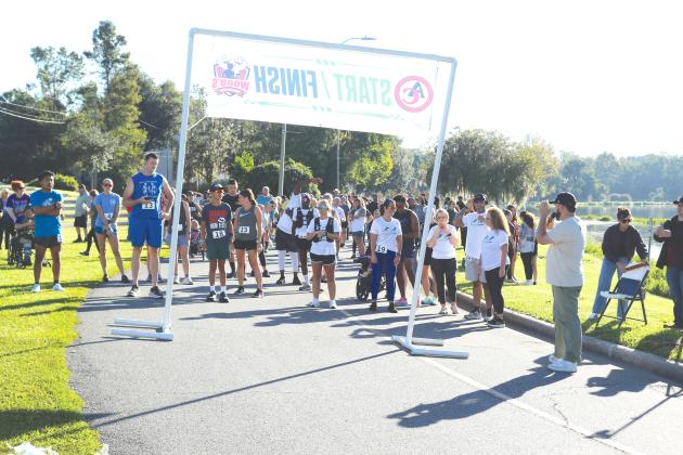 Runners at the Pregnancy Care Center 5K Walk/Run for Life get set up near the starting line of Saturday’s event. Hundreds turned out for the fundraiser. (TONY BRITT/Lake City Reporter)