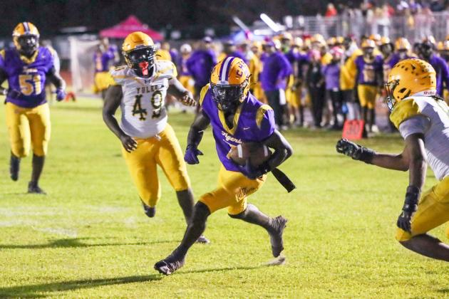 Columbia receiver Kyren Caldwell splits the Yulee defense for one of his three touchdowns Friday night. (BRENT KUYKENDALL/Lake City Reporter)