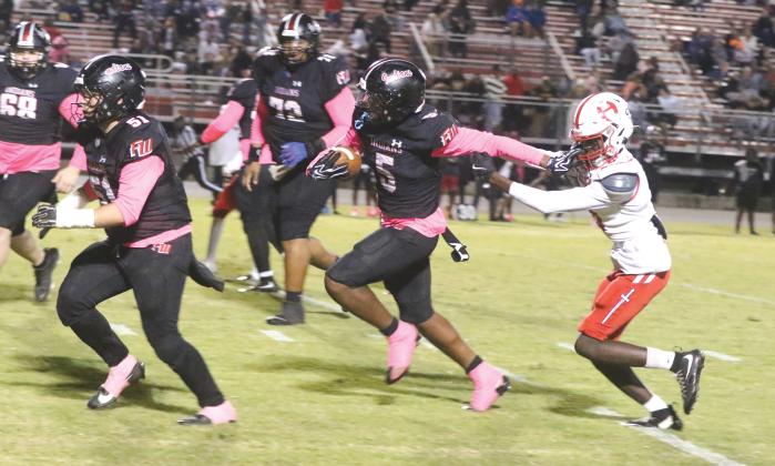 Fort White receiver Brandon Robinson stiff-arms Hamilton County defensive back Avrin Johnson on his way to a 35-yard touchdown in Friday’s 41-0 win. (MORGAN MCMULLEN/Lake City Reporter)