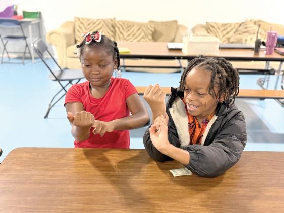 Two students at Minnie J. Niblack Elementary School practice locating their pulse on their wrists during a 4-H Choose to Move lesson. Through hands-on discovery, students learned how their hearts respond to physical activity and why keeping their hearts healthy is an important part of taking charge of their health. (COURTESY COLUMBIA COUNTY EXTENSION)