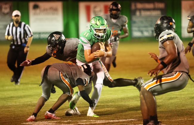 Suwannee quarterback Haigen Johnson braces for a hit from Zarephath Academy last Friday. (PAUL BUCHANAN/Lake City Reporter)