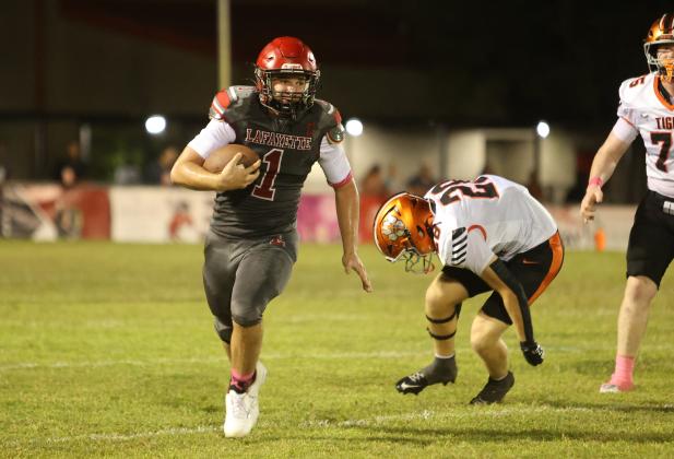 Lafayette quarterback Trevor Byrd turns the corner of the Trenton of the defense for a gain last Friday. (PAUL BUCHANAN/Lake City Reporter)