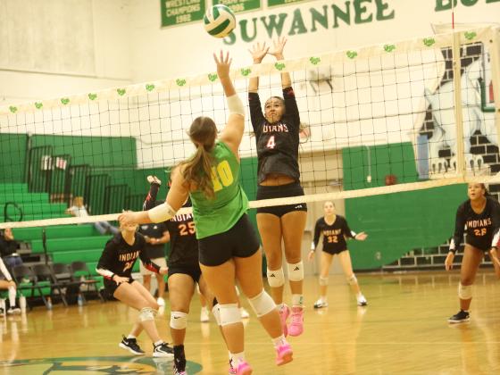 Fort White hitter Arianna Breeden (4) attempts to block a shot from Suwannee hitter Calinn Daniel on Aug. 25. (PAUL BUCHANAN/Lake City Reporter)