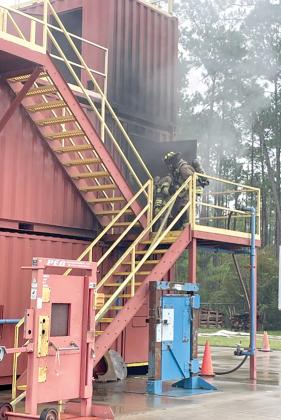 Lake City firefighters enter the burning building simulation at Florida Gateway College’s Public Safety Training Campus in Olustee. The firefighters were conducting one of their two training sesions at Olustee on Tuesday. (COURTESY LAKE CITY FIRE DEPARTMENT)