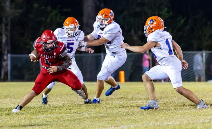 Lafayette quarterback Trevor Byrd looks for running room against Branford on Friday. (JACK HOWDESHELL/Lake City Reporter)