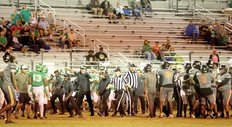 Suwannee head coach Kyler Hall and assistants PJ Davis, Kendrick Carter and Brian Wilder try to get the Bulldogs, including Jadayce Jones (13) to get away after a skirmish broke out late in the third quarter Friday against Zarephath Academy. Officials try to keep the Zarephath players separated. The game ended moments later when the Eagles decided to quit after having one player previously ejected as well. (PAUL BUCHANAN/Lake City Reporter)