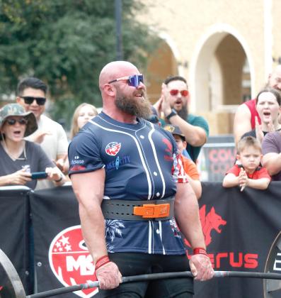 Strongman Tristain Hoath flashes a smile to the crowd as he deadlifts more than 800 pounds for a sixth time in a minute Saturday at Olustee Park as part of the Strongman Champions League competition. (JAMIE WACHTER/Lake City Reporter)