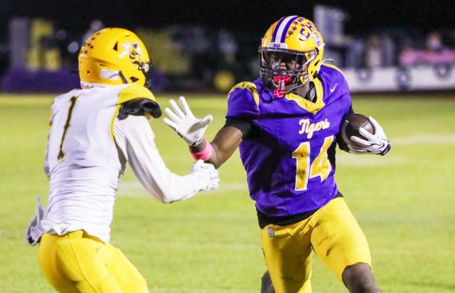 Columbia receiver Zion Walker stiff-arms Yulee defender Pete Kuhlman as he runs down the sideline after a catch on Friday. (BRENT KUYKENDALL/Lake City Reporter)