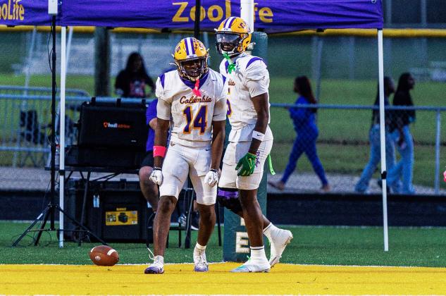 Columbia receiver Zion Walker (14) celebrates alongside Jaylon Willis after scoring on a 65-yard catch-and-run against Ed White on Friday. (JAMARION WEST/Special to the Reporter)