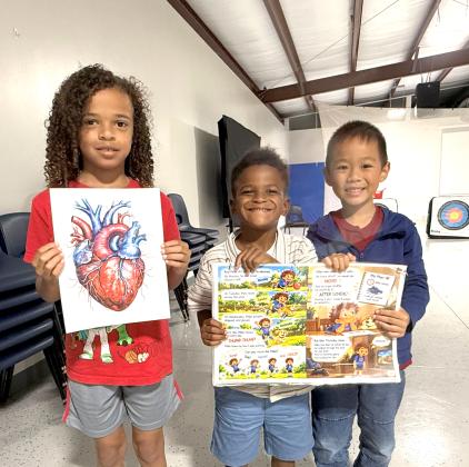 Westside Elementary School students proudly display illustrations used during October’s Choose to Move lesson, including an anatomical heart and pages from Miles Has a Plan! The hands-on learning experience helped students better understand how their hearts work and how planning for daily physical activity supports lifelong health. (COURTESY COLUMBIA COUNTY EXTENSION)