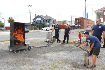 Easton Starling, 11, utilizes training he learned at a Lake City Fire Department summer camp to douse flames with a fire extinguisher. (TONY BRITT/Lake City Reporter)
