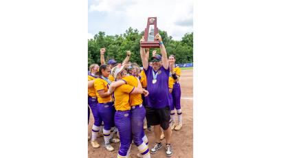 Columbia coach Joe Saucier raises the Class 4A championship trophy after the Tigers defeated Lake Wales on May 23. (JACK HOWDESHELL/Lake City Reporter)