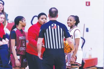 Fort White coach Bregay Harris questions a call to a referee while guard Javiona Roberson (right) smiles during the Region 3-R semifinals against Madison County on Feb. 13. (FILE)