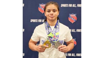 Recent Columbia graduate Bella Guerrier-Lajoir shows off her medals after going 8-0 to earn All-American honors at the AAU Scholastic Duals over the weekend. (COURTESY)
