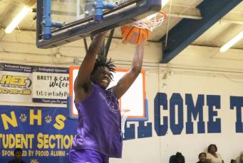 Columbia center Ty’avious Cooper dunks against Newberry during the Tigers’ summer league finale on Tuesday. (JORDAN KROEGER/Lake City Reporter)